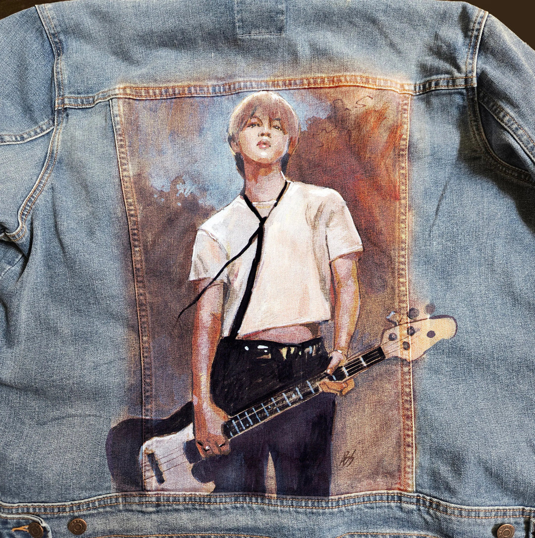 Close-up detail of hand-painted Jimin portrait on denim jacket