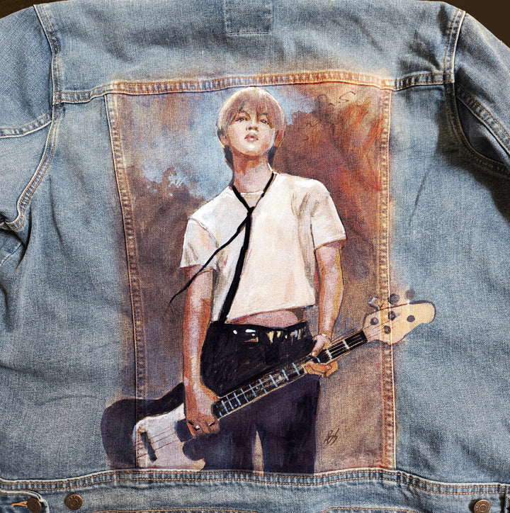 Close-up detail of hand-painted Jimin portrait on denim jacket