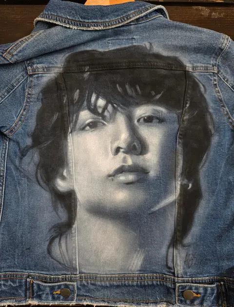 Airbrushed portrait of Jungkook from BTS on denim jacket